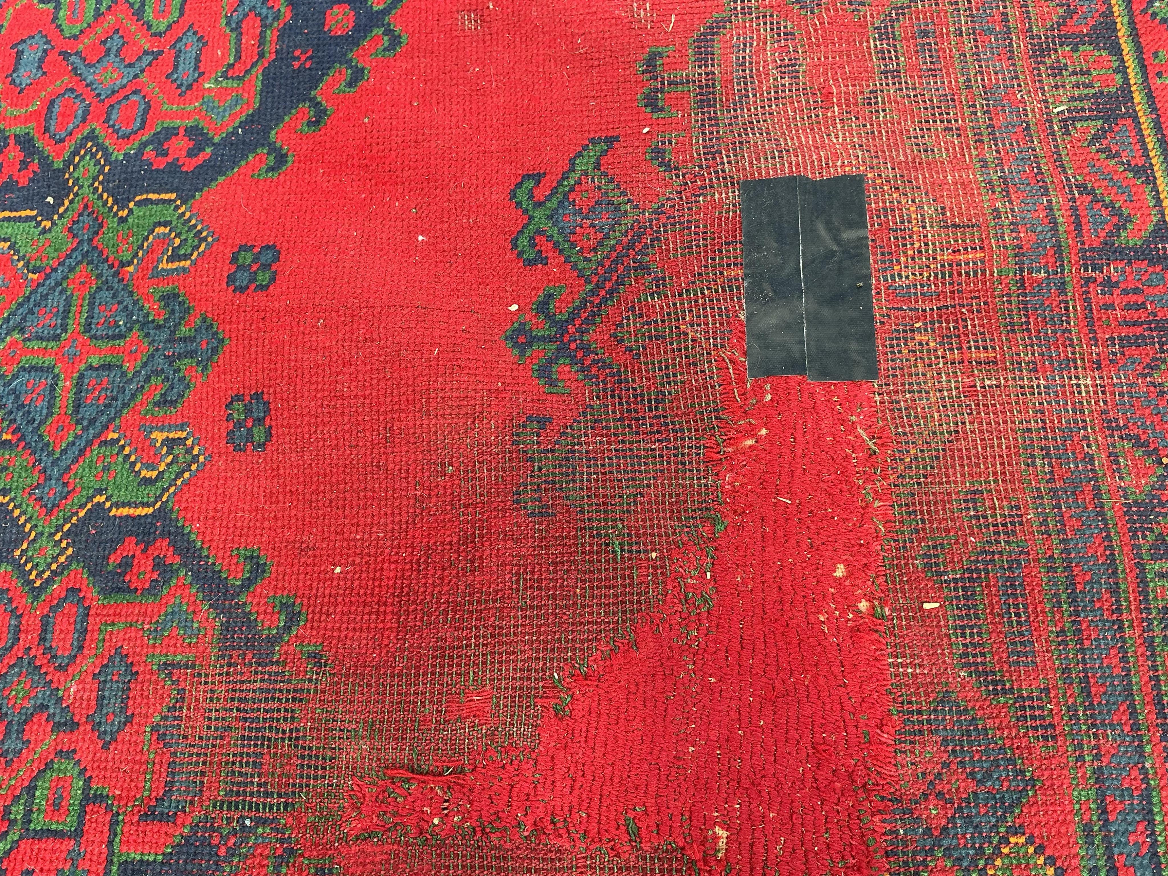 An early 20th century Afghan red ground carpet, 445 x 375cm